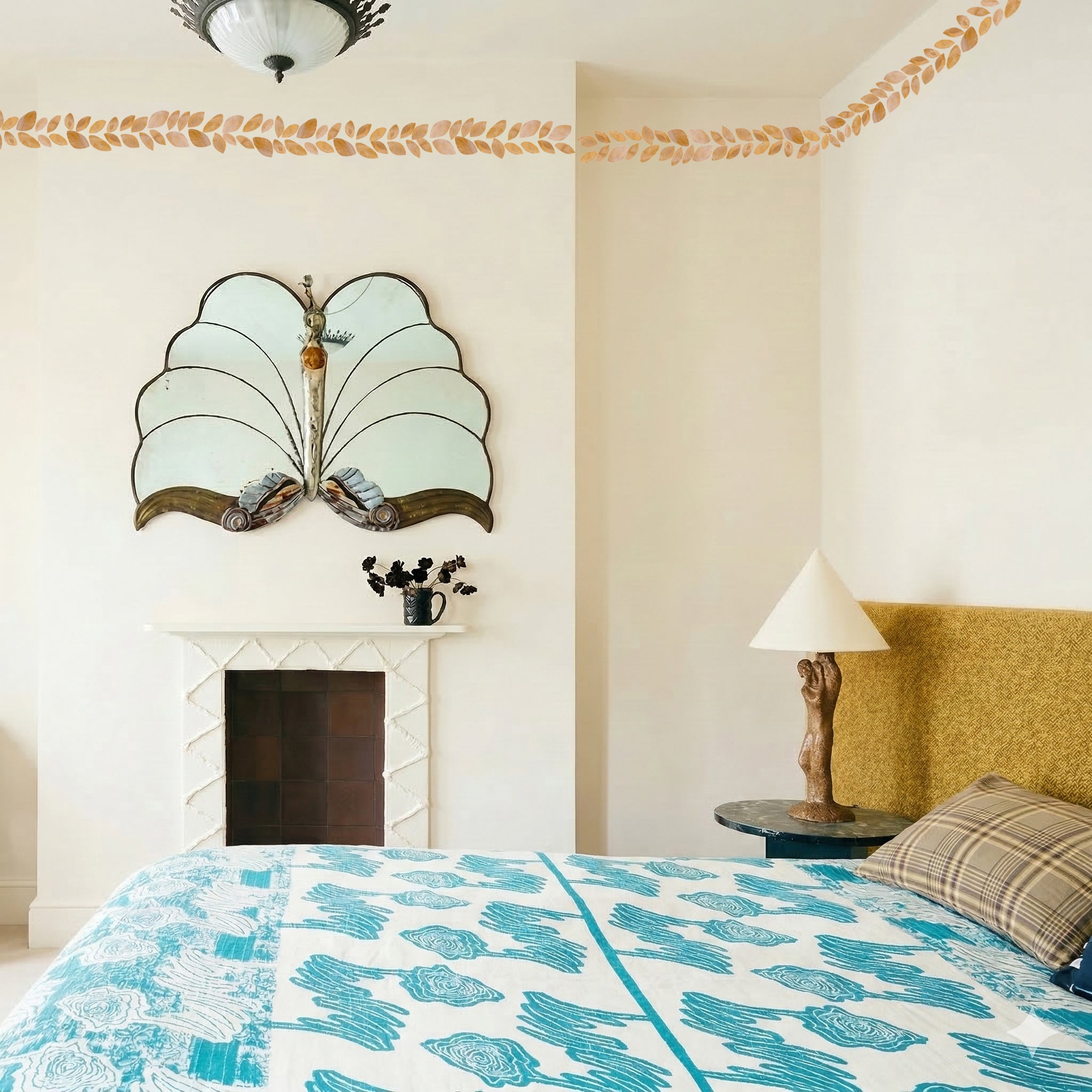 gold leaves wallpaper border in bedroom near ceiling